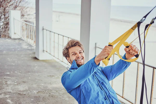 Man has a workout with special bandages — Stock Photo, Image