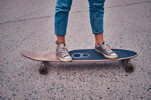 Womam is riding longboard on the street — Stok Foto