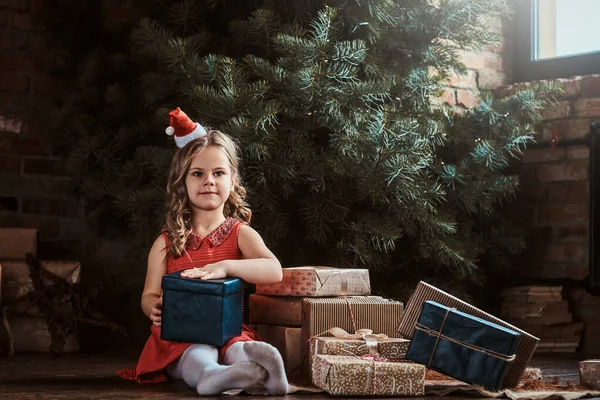 Portrait of cute little girl near christmas tree — Stock Photo, Image