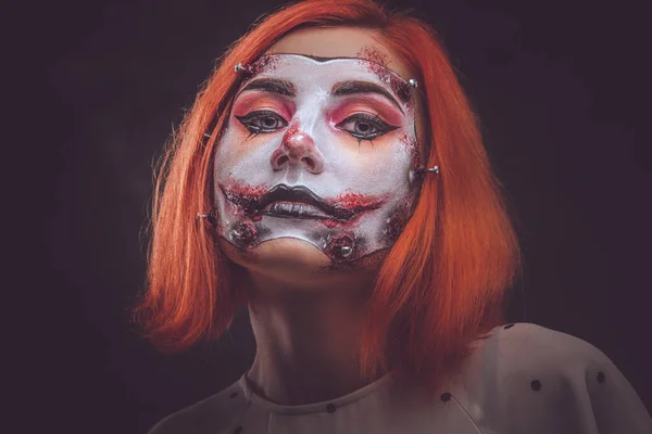 Portrait of ginger girl with scary doll art on face — Stock Photo, Image