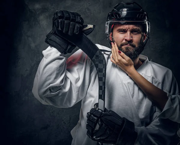 Portrait of brutal hockey player with woman hand — Stock Photo, Image