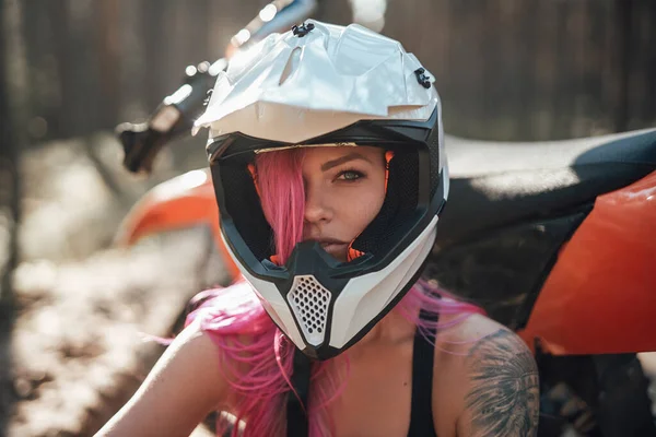 Menina hipster bonita com uma tatuagem em seu braço e cabelo rosa cobrindo o olho no capacete de segurança — Fotografia de Stock