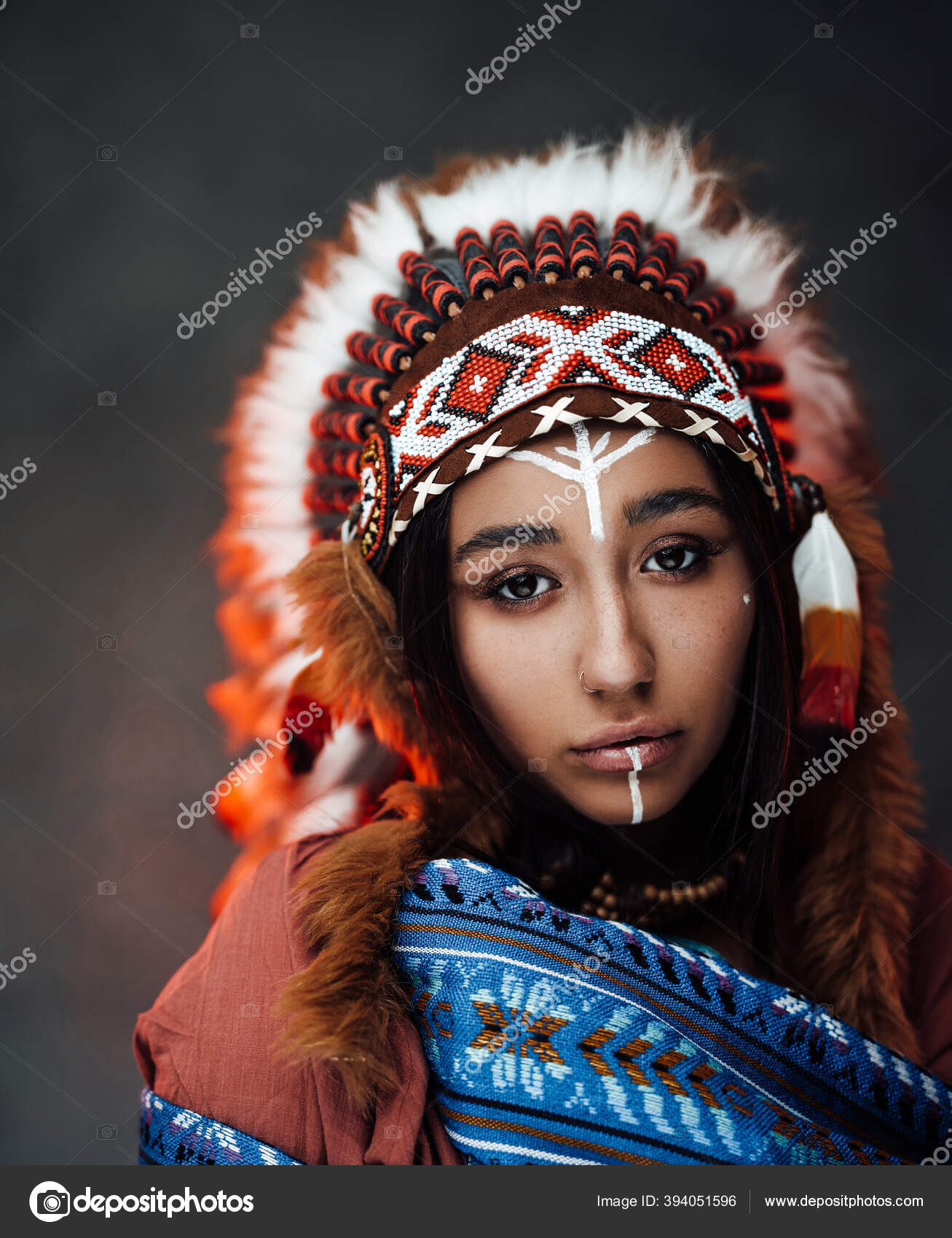 Portrait of a beautiful American Indian woman in ethnical costume and