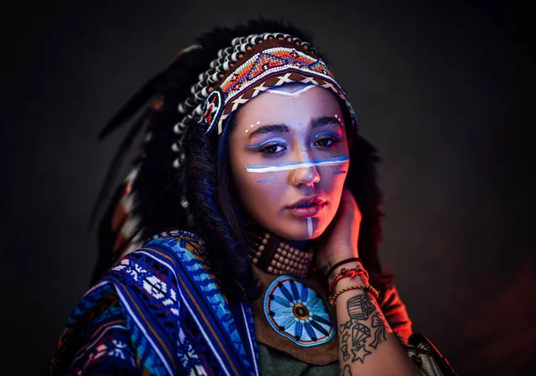 Charming American Indian girl with tattoo on hand in traditional make up hat and clothes — Stock Photo, Image