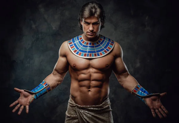 Atletische man in Egyptische kostuum, het uitvoeren van zijn prestaties van kracht — Stockfoto