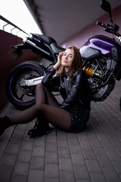 Uma mulher bonita urbana com sua motocicleta personalizada — Fotografia de Stock