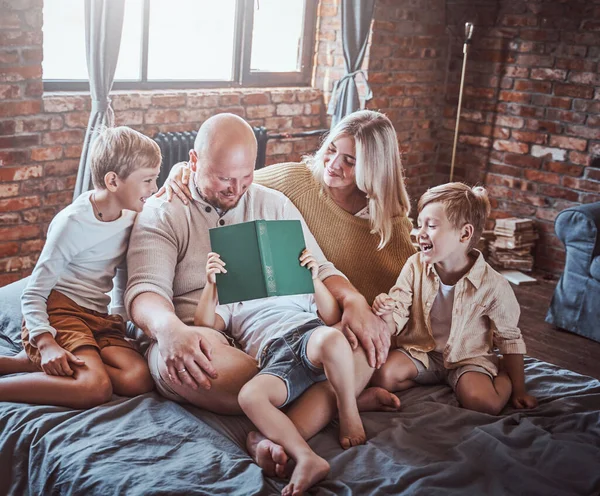 Positive parents resting in living room with their boys — Stock Photo, Image