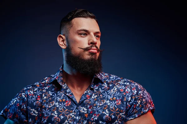 Brutal e também elegância cara com barba posando em fundo azul — Fotografia de Stock