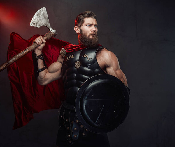 Stationary greek warrior with shield and axe in studio