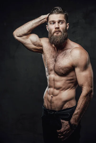 Bearded guy with naked torso posing in dark background — Stock Photo, Image