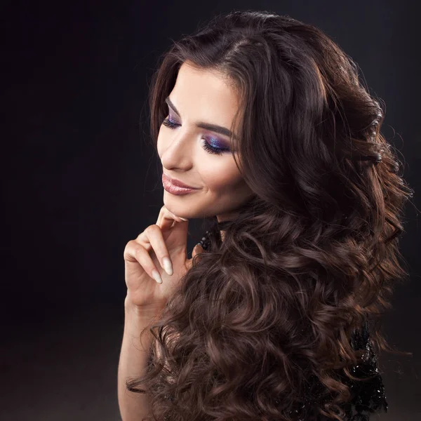 Lyxigt hår. Porträtt av en ung attraktiv kvinna med vackra lockiga hår. Attraktiv brunett — Stockfoto
