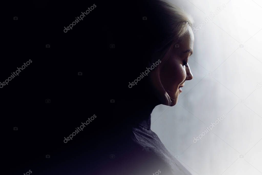 Portrait of a young calm woman in profile. Concept of the inner world and psychology, the dark and light side of personality. 