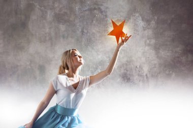 Young attractive woman reaching for the star. Take a star from the sky, dreams and plans, concept clipart