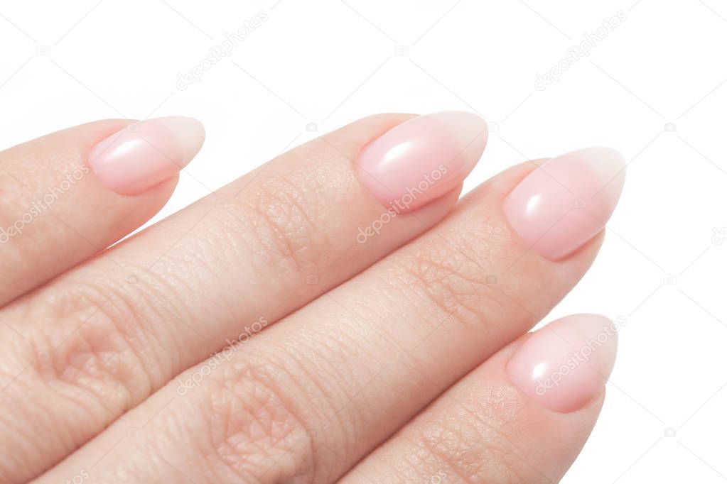 Women's hands with perfect Nude manicure. Nail Polish is a natural pale pink shade. Isolated on white