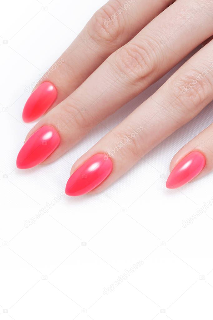 Women's manicure, on a white background. Nail Polish red coral color.