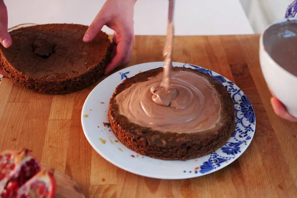 Two girls making a cake on the kitchen.