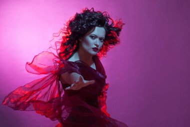 Kırmızı elbise uçan ile dans eden kadın. Bir cadı gibi güzel Gotik kız