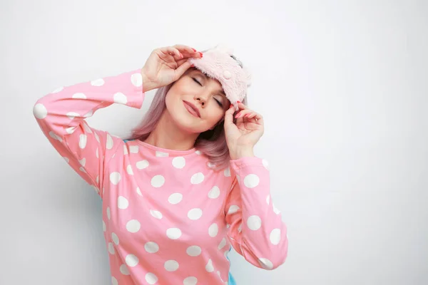 Linda jovem loira em pijama rosa e uma máscara de sono — Fotografia de Stock