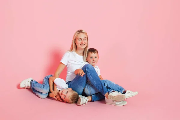 happy mom with two happy sons. Young woman and two baby boys