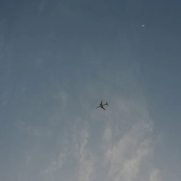 Latanie samolotem wysokiej na niebie, małe sylwetka chmury — Zdjęcie stockowe