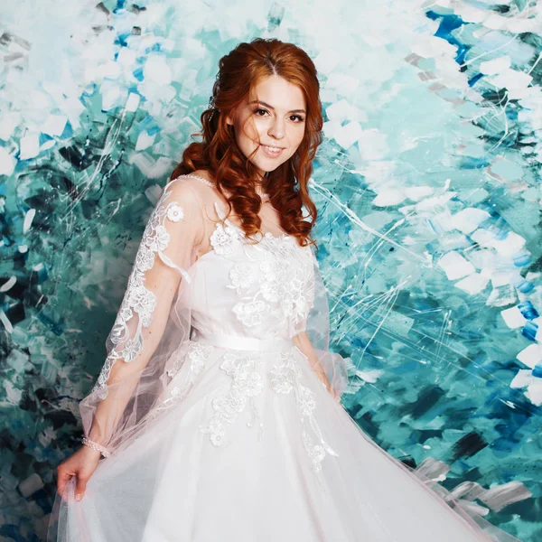 Beautiful and romantic bride in wedding dress with long sleeves. Young redheaded woman in wedding dress — Stock Photo, Image
