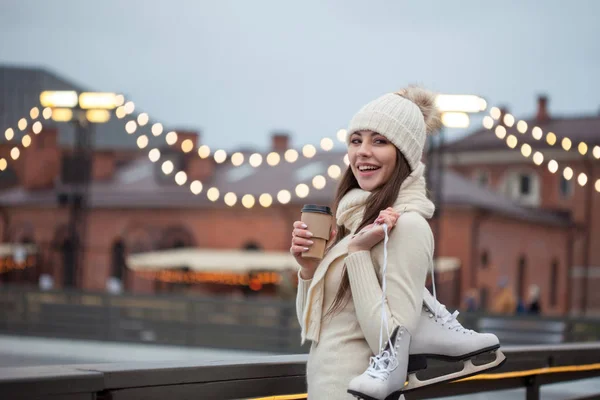 Felice giovane donna in maglia maglione e cappello sta andando pattinaggio — Foto Stock