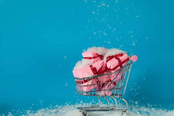 Vendas de Natal. Comprar presentes para o ano novo, o conceito. O carrinho de compras está cheio de caixas de presente — Fotografia de Stock