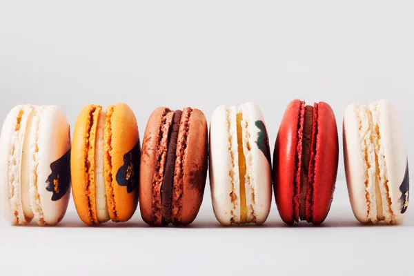 Elegant French desserts with different fillings. Set of colorful macaron