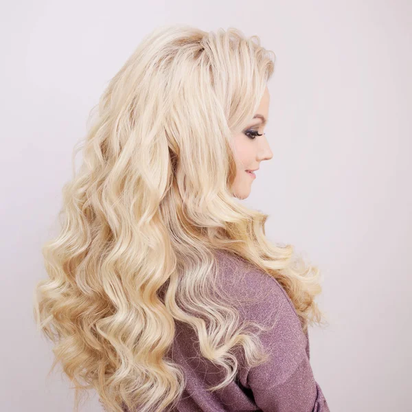 Back view of blonde with long luxurious curls. — Stock Photo, Image