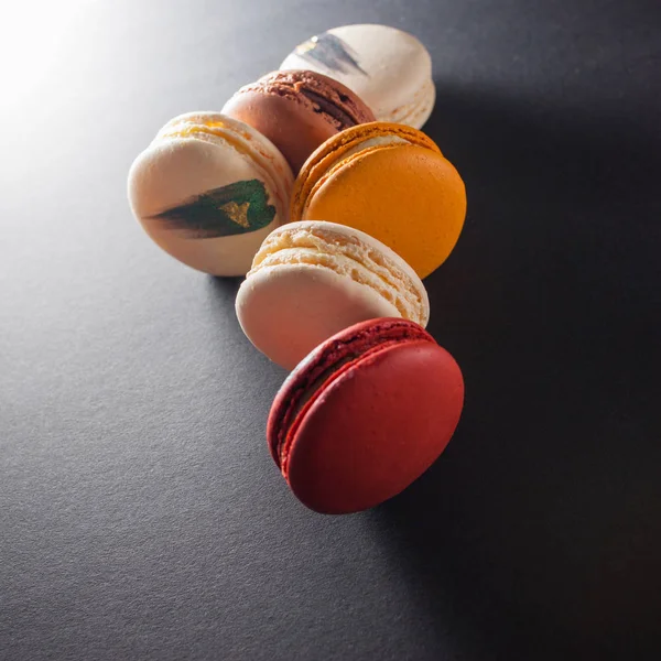 Elegant French desserts. Set of colorful macaron decorated by toppings.