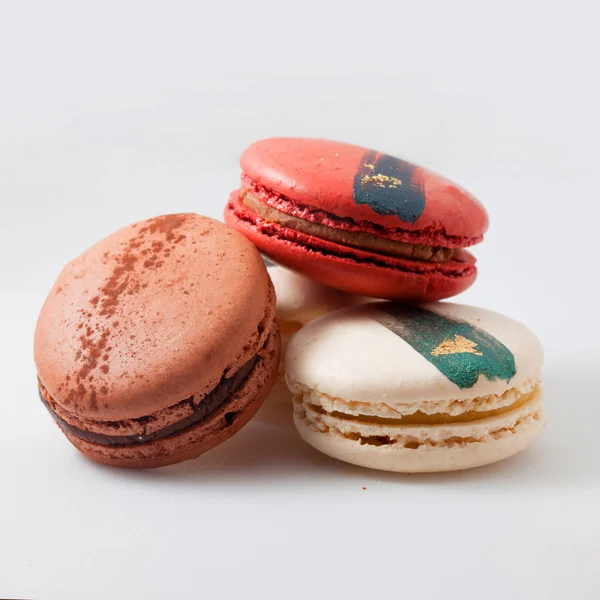 Elegant French desserts. Set of colorful macaron decorated by confectionery colours and toppings.