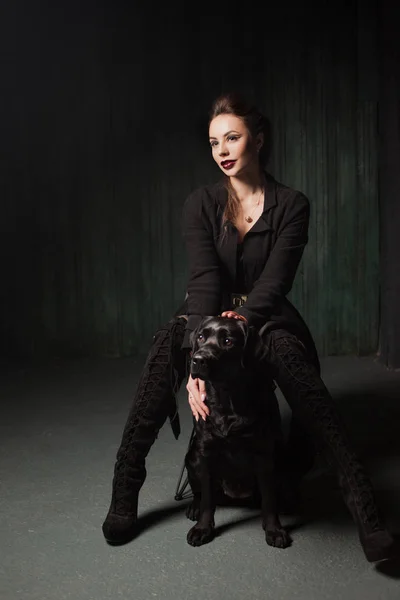 Elegante e sexy donna in nero con Labrador nero . — Foto Stock