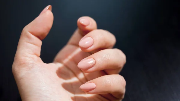 Nude manicure with gold decor. Womens hands close up — Stock Photo, Image