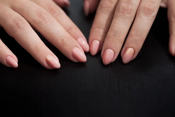 Nude manicure with gold decor. Womens hands close up — Stock Photo, Image