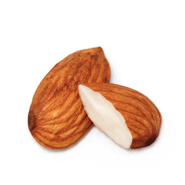 Almond close - up isolated on white. Whole almonds and half a nut — Stock Photo, Image
