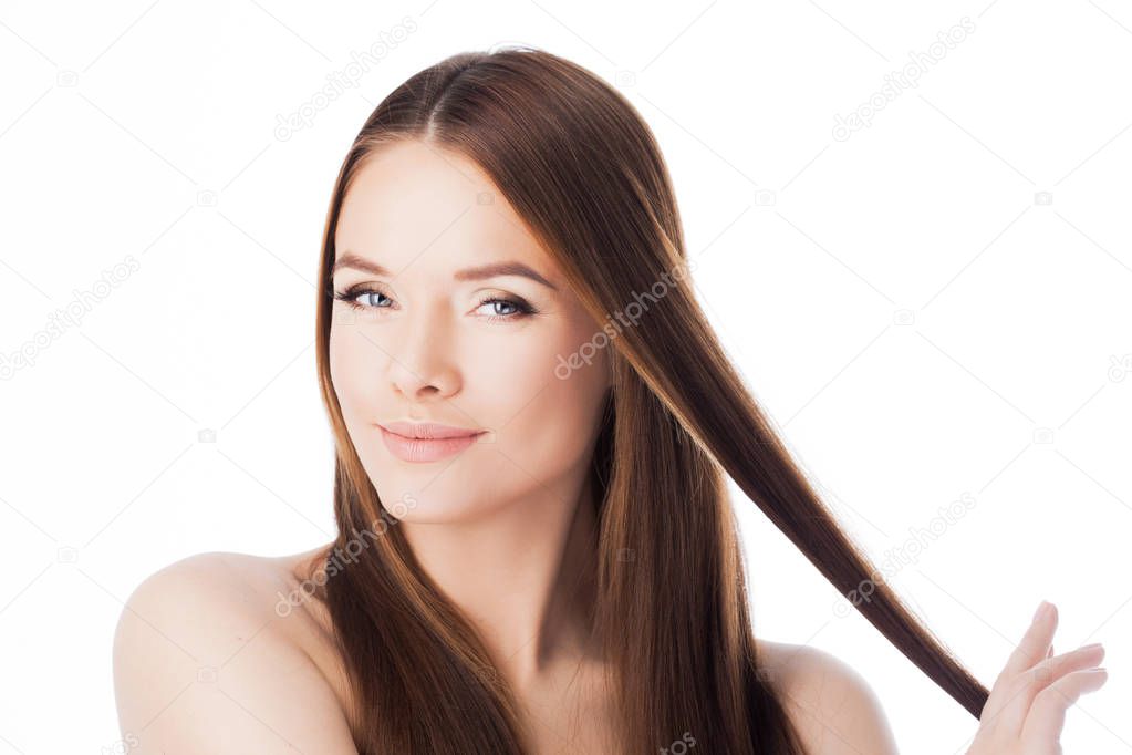 Gorgeous hair. portrait of a beautiful girl with long silky hair. Attractive young woman with a strand of hair.