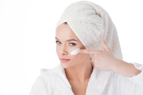 To use the cream after a shower. Portrait of a young attractive woman in a Bathrobe and a towel on her head. Stock Image