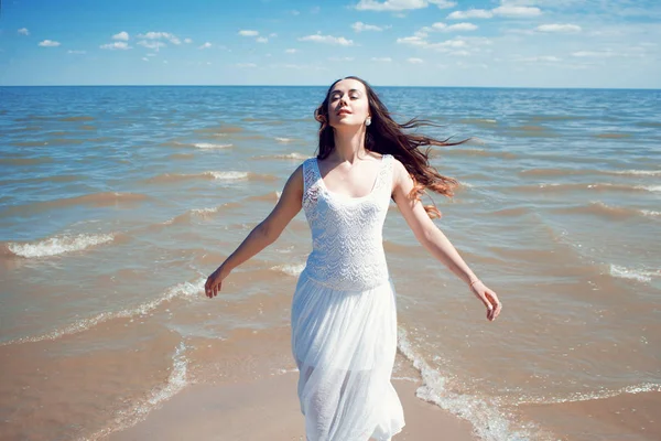 Young beautiful brunette woman in white dress — Stock Photo, Image