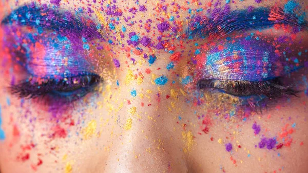 Explosion of color, multi-colored shadows scattered on the eyelids. Colored Smokey eyes and blue eyebrows. — Stock Photo, Image