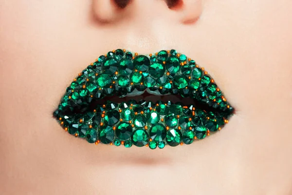 Green lips covered with rhinestones. Beautiful woman with Green lipstick on her lips