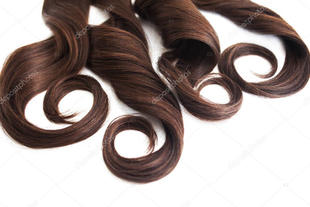 strand of brunette hair isolated on white, luxurious brown hair on white, free space for text