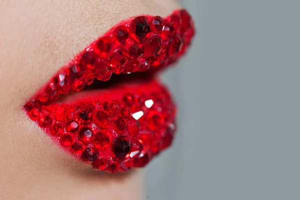 Red lips covered with rhinestones. Beautiful woman with red lipstick on her lips — Stock Photo, Image