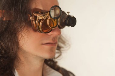 Vintage style researcher mechanist of the monocle with a large number of lenses looking at something clipart