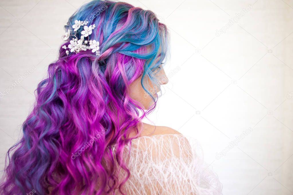 Beautiful and healthy hair with bright coloring. Long curly hair purple and pink tones