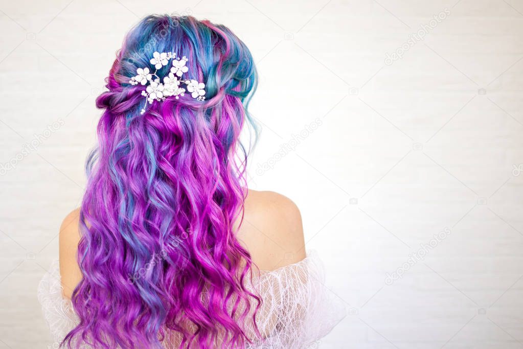 Beautiful and healthy hair with bright coloring. Long curly hair purple and pink tones