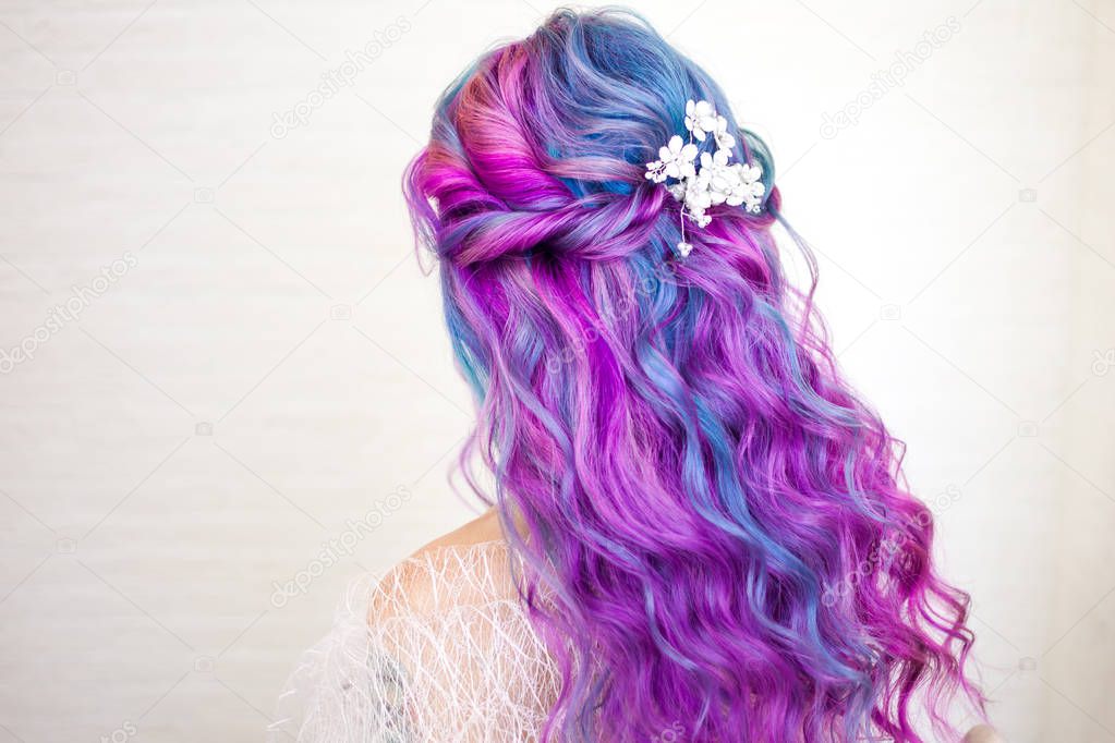 Beautiful and healthy hair with bright coloring. Long curly hair purple and pink tones