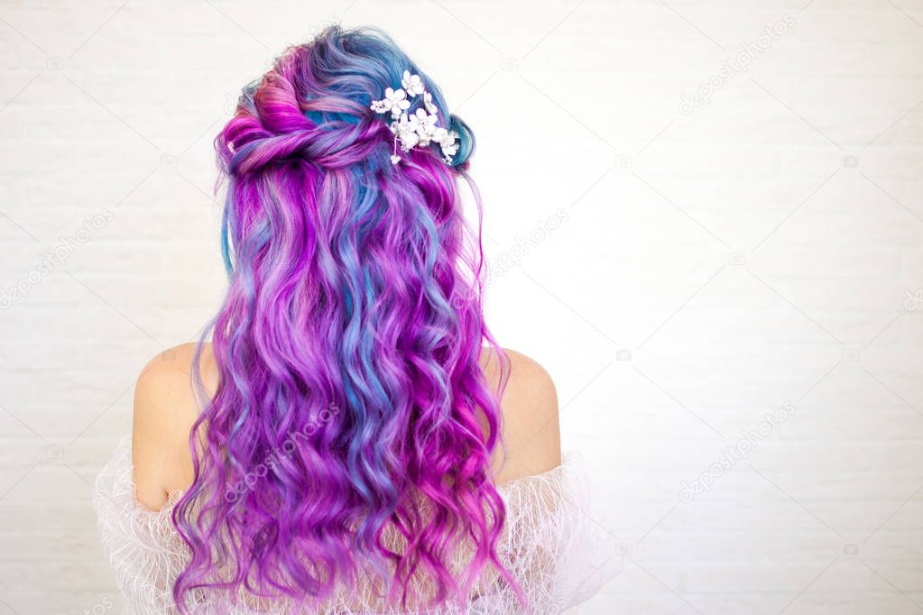 Beautiful and healthy hair with bright coloring. Long curly hair purple and pink tones