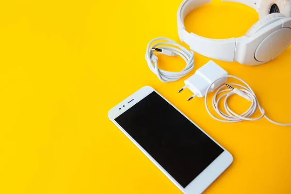 Mobile kit with smartphone, headphones and chargers. — Stock Photo, Image