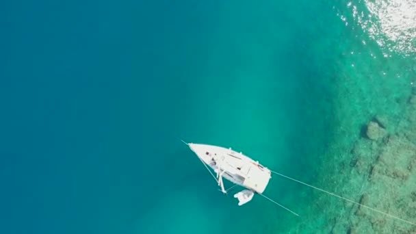 Plachtění jachta kotvící na břehu, nádherné moře drone video. — Stock video