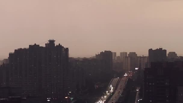 Evening city in the haze, panorama of the city with the highway, cars go with headlights on. — Stock Video